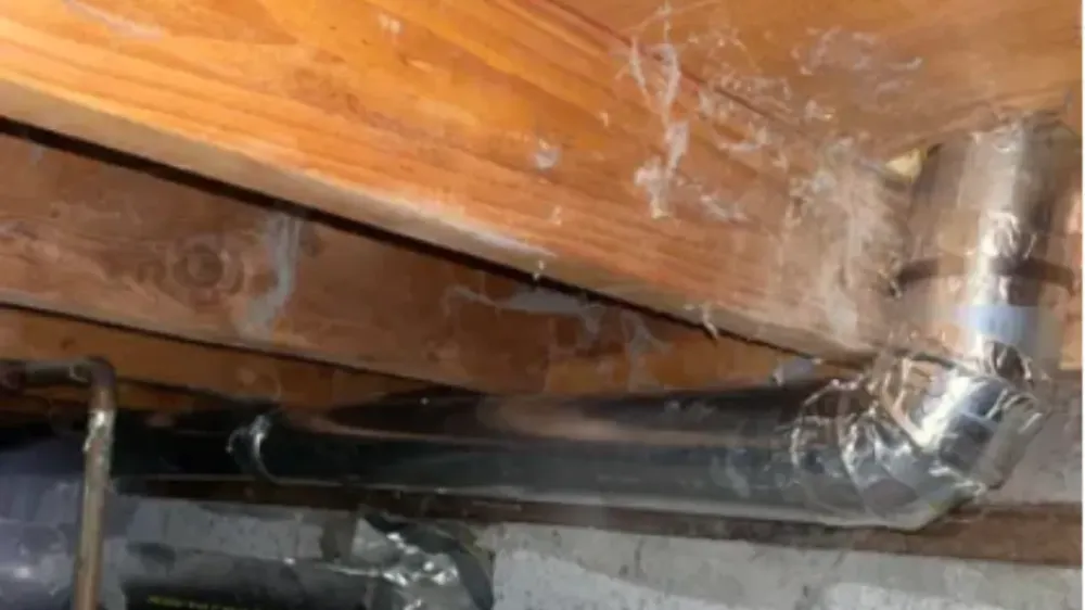 Dryer duct run under a floor joist
